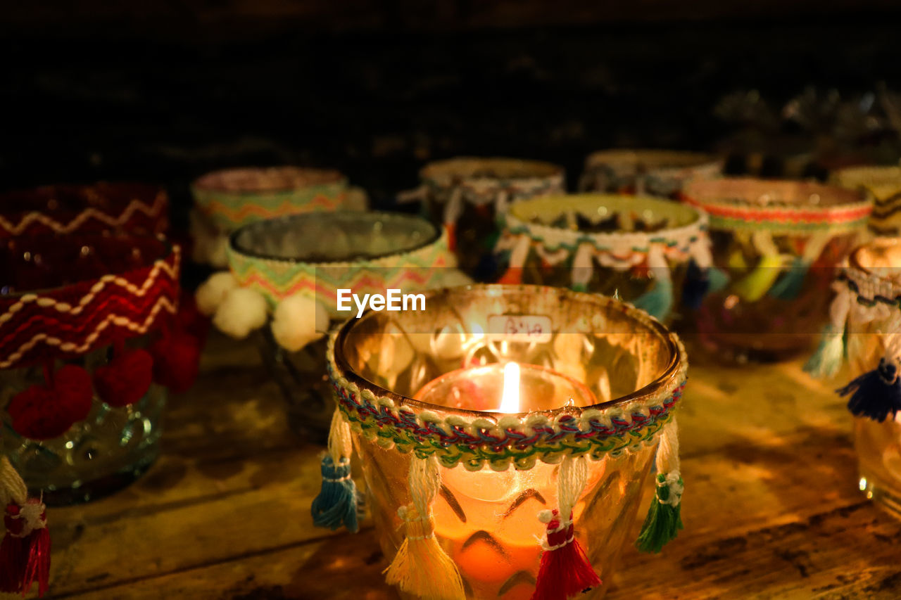 Close-up of lit candles on table