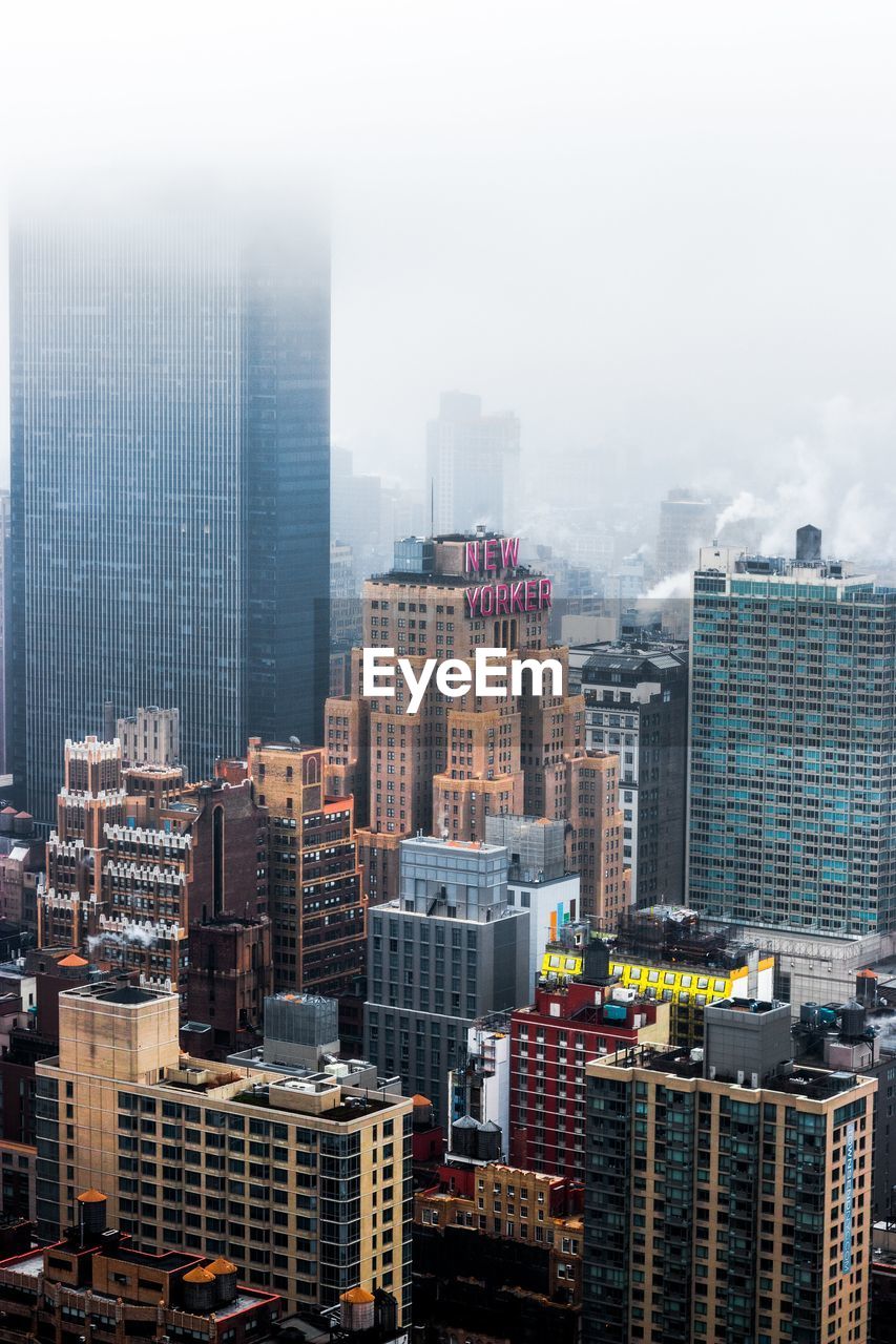 HIGH ANGLE VIEW OF BUILDINGS IN CITY AGAINST SKY