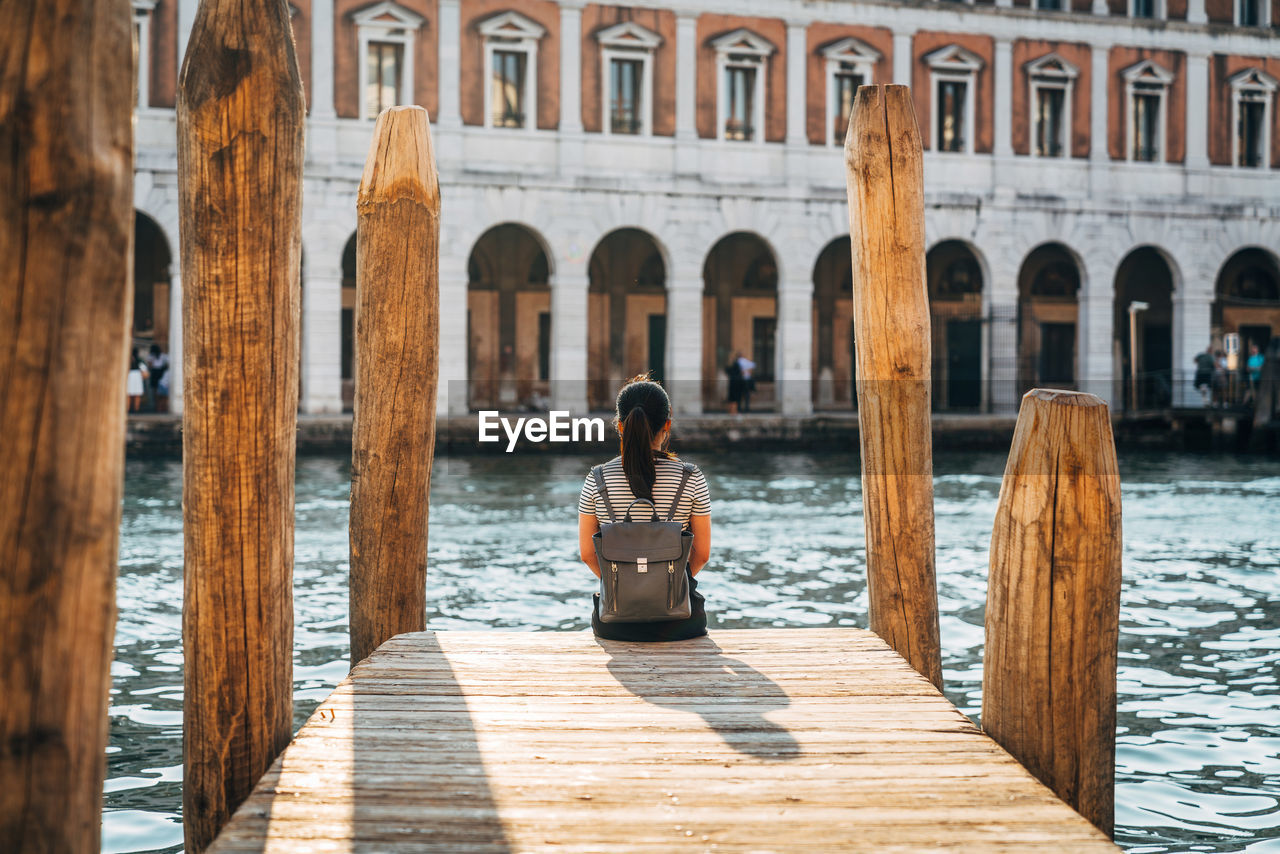 Tourist on jetty in venice