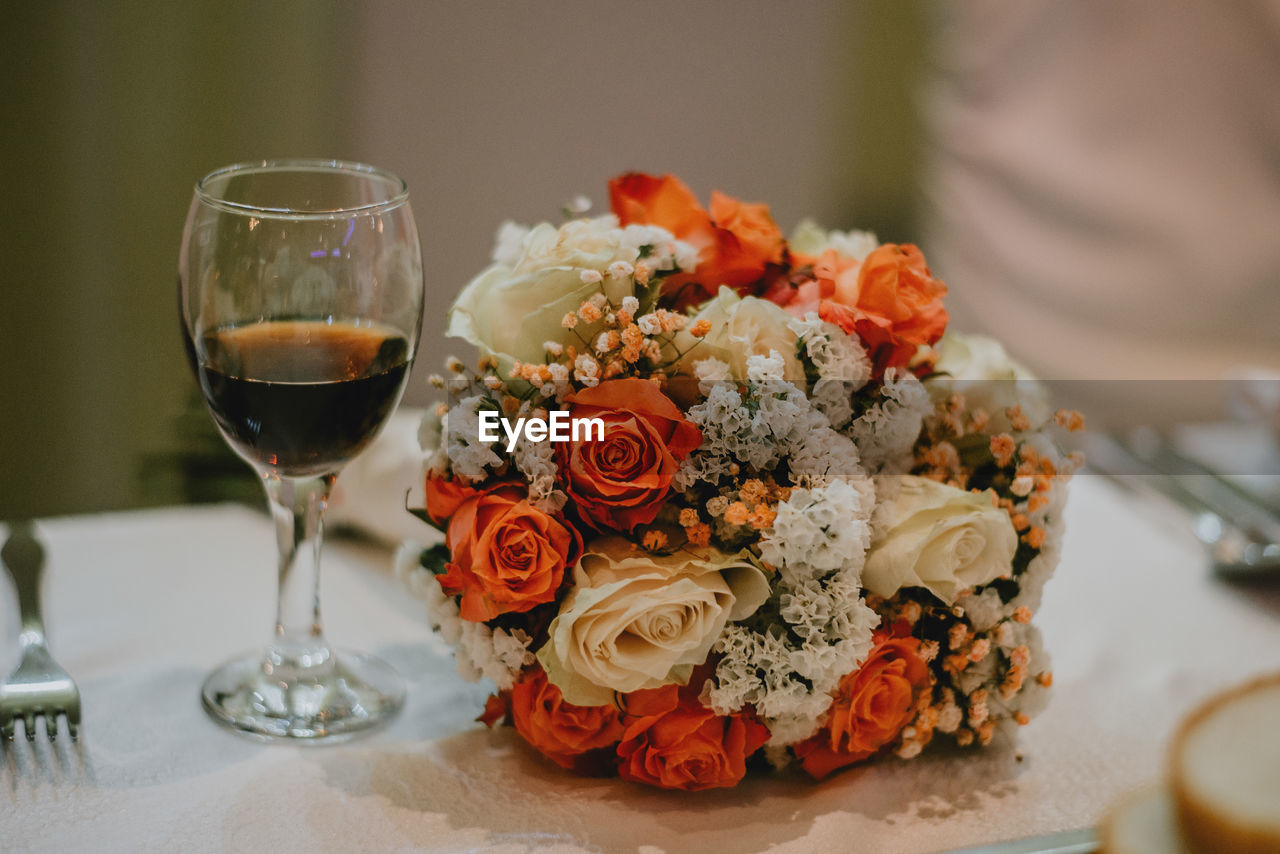 CLOSE-UP OF ROSES SERVED ON TABLE AT HOME