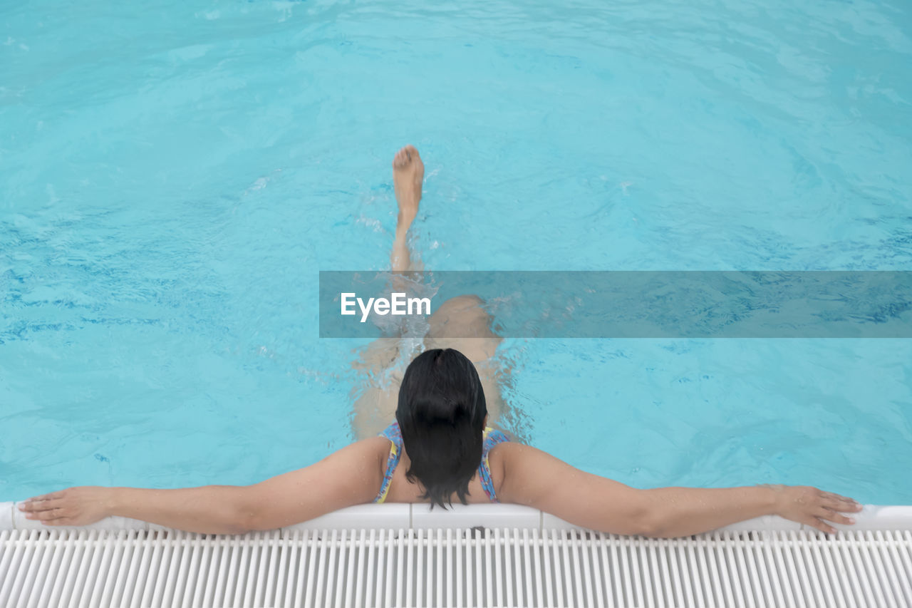 High angle view of woman swimming in pool