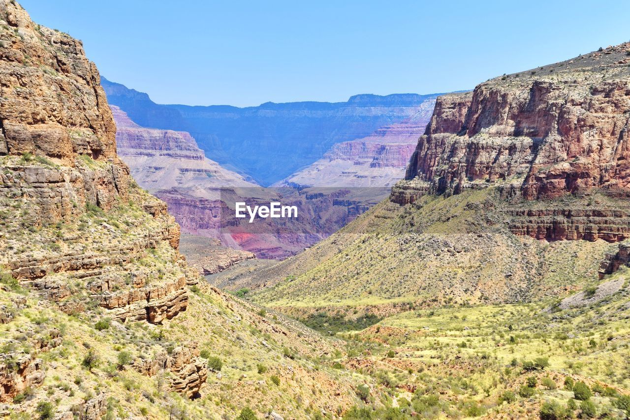 AERIAL VIEW OF ROCKY MOUNTAINS AGAINST SKY