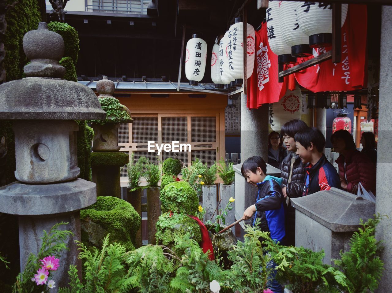 GROUP OF PEOPLE IN TRADITIONAL BUILDING