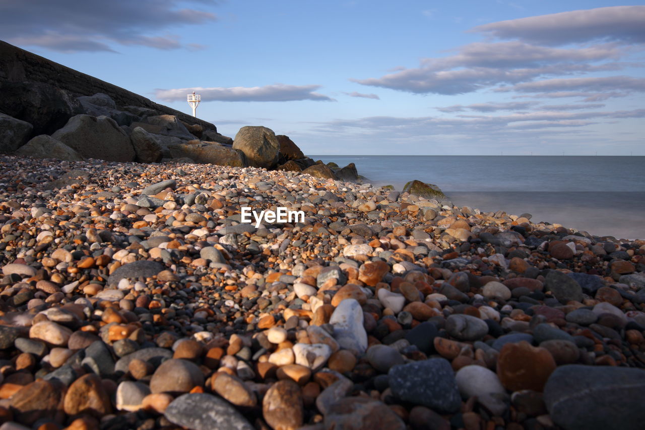 Rocks on beach against sky