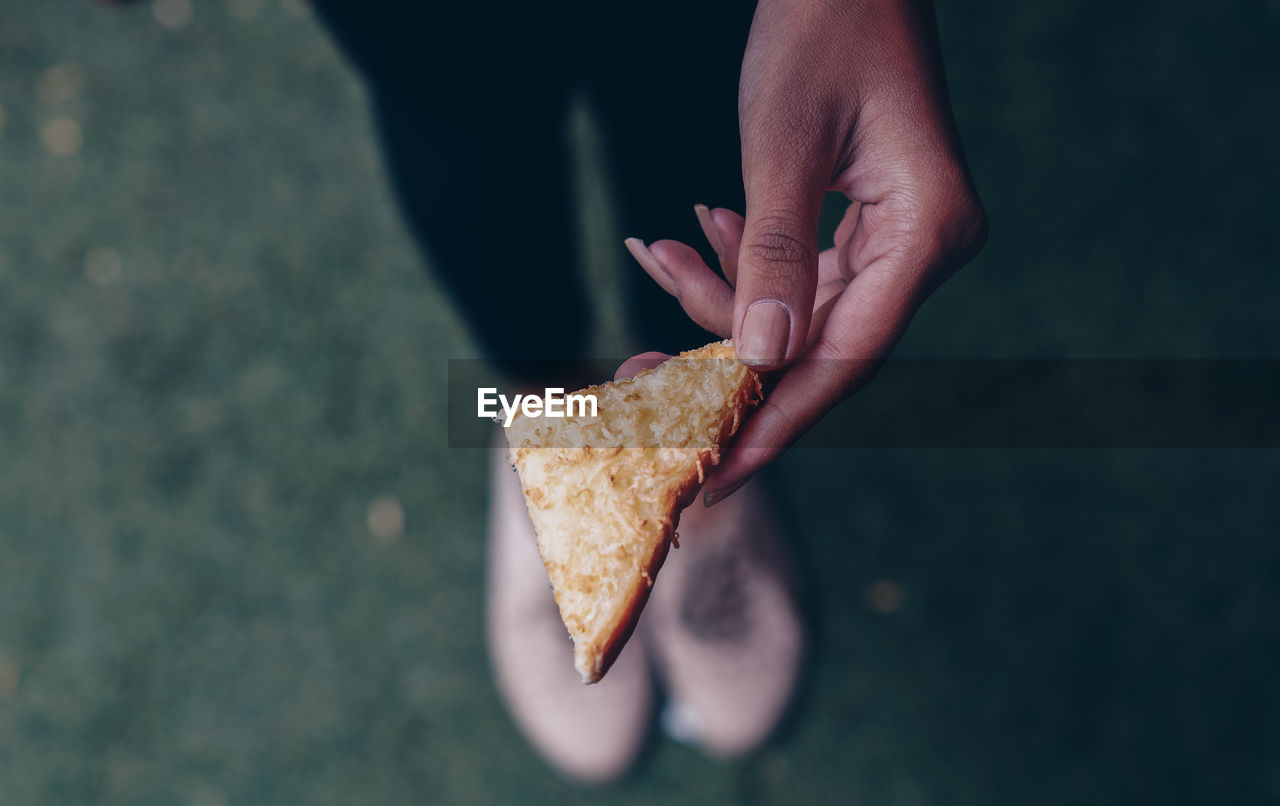 CLOSE-UP OF HAND HOLDING ICE CREAM CONE