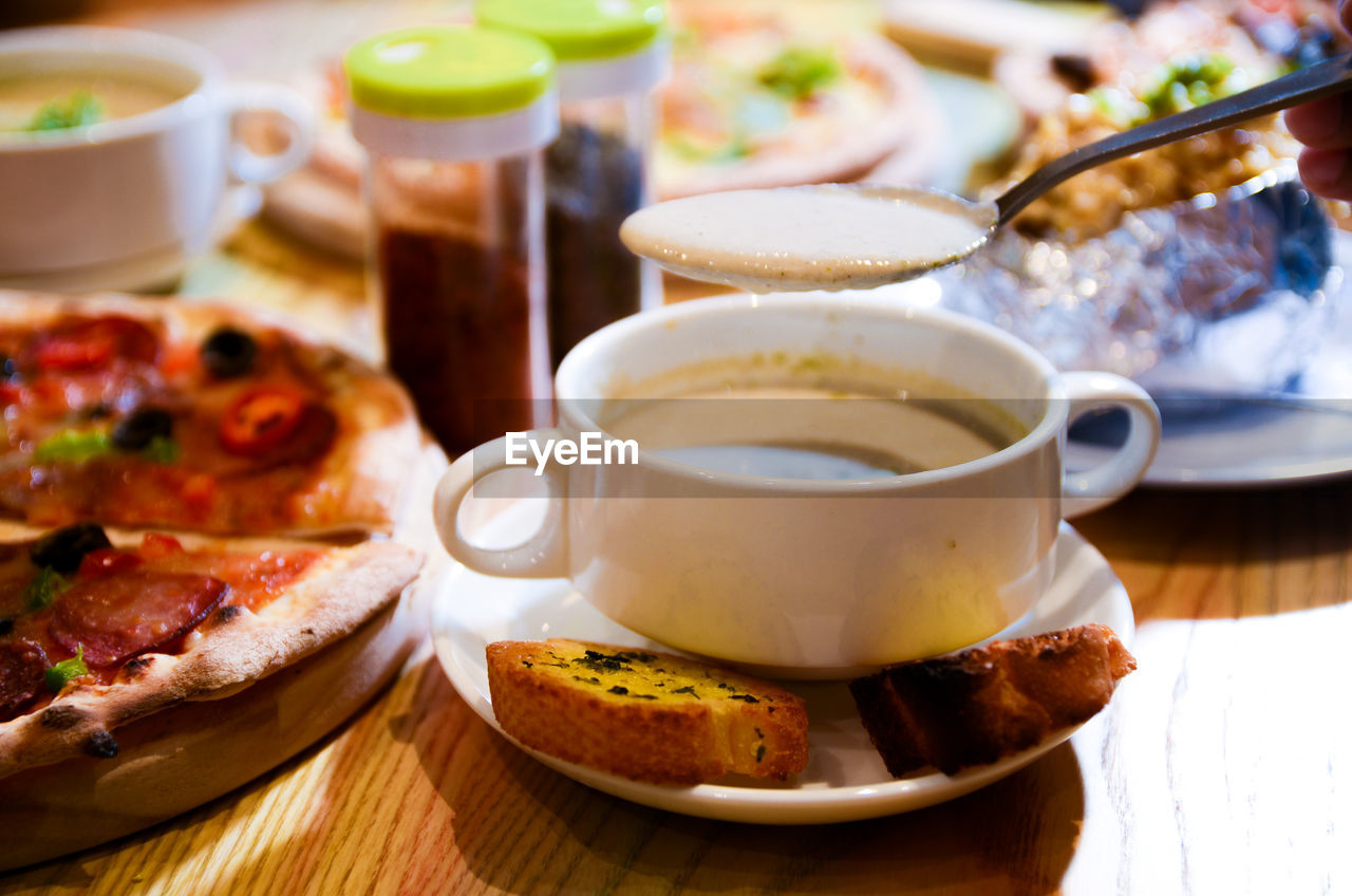 CLOSE-UP OF COFFEE AND CUP ON TABLE