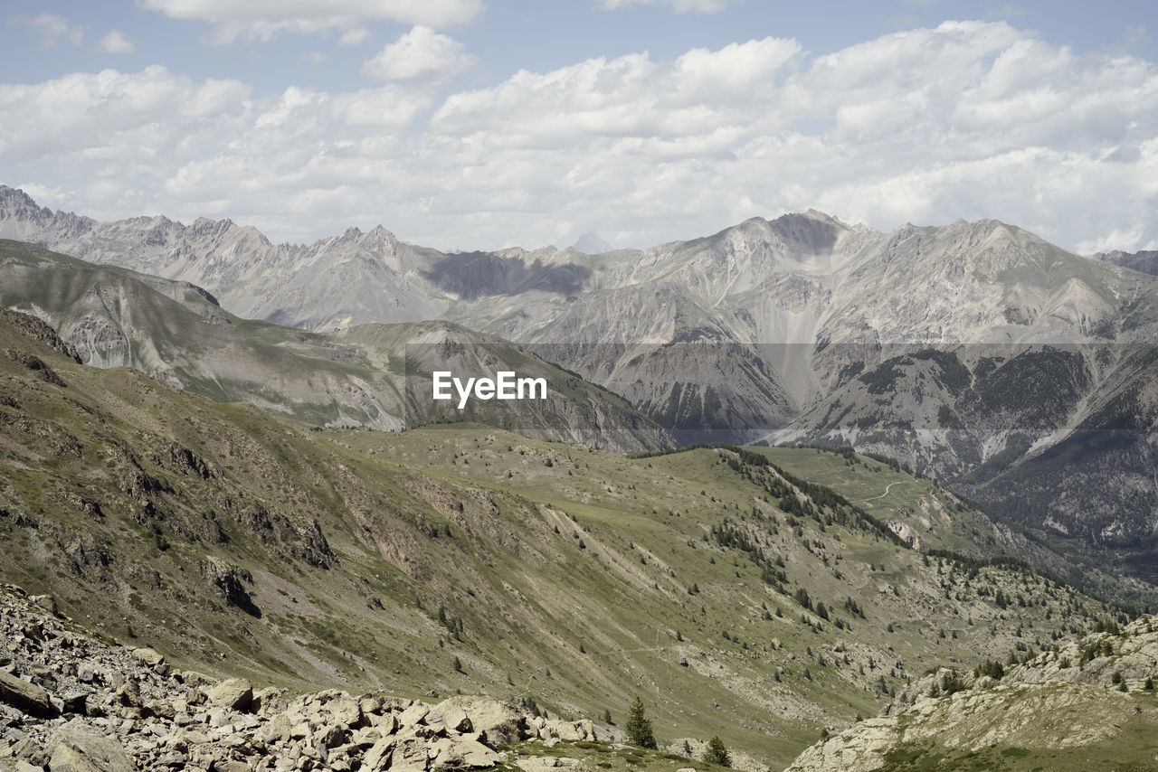 Scenic view of mountains against cloudy sky