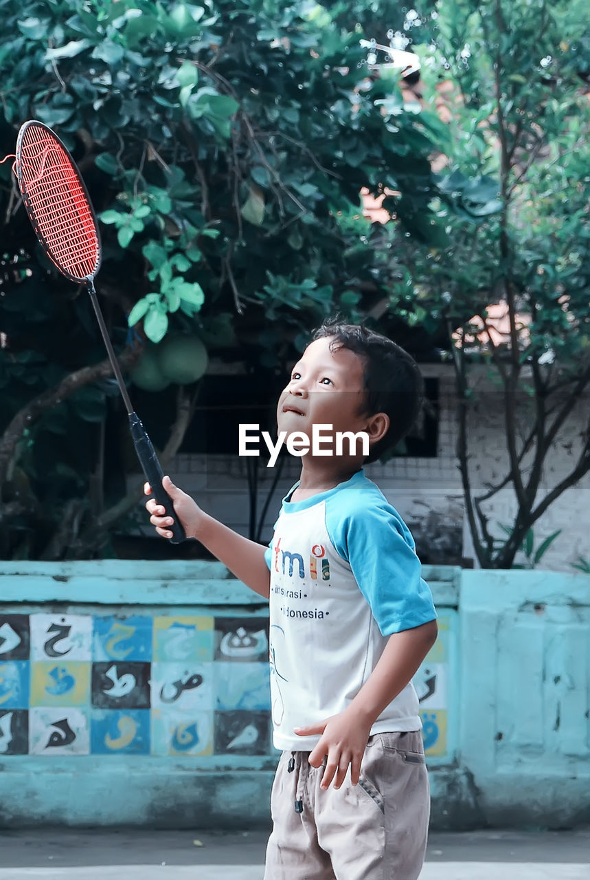 Boy playing badminton with recket