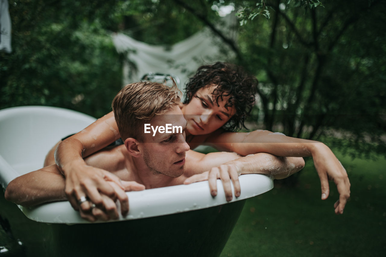 Couple in bathtub outdoors