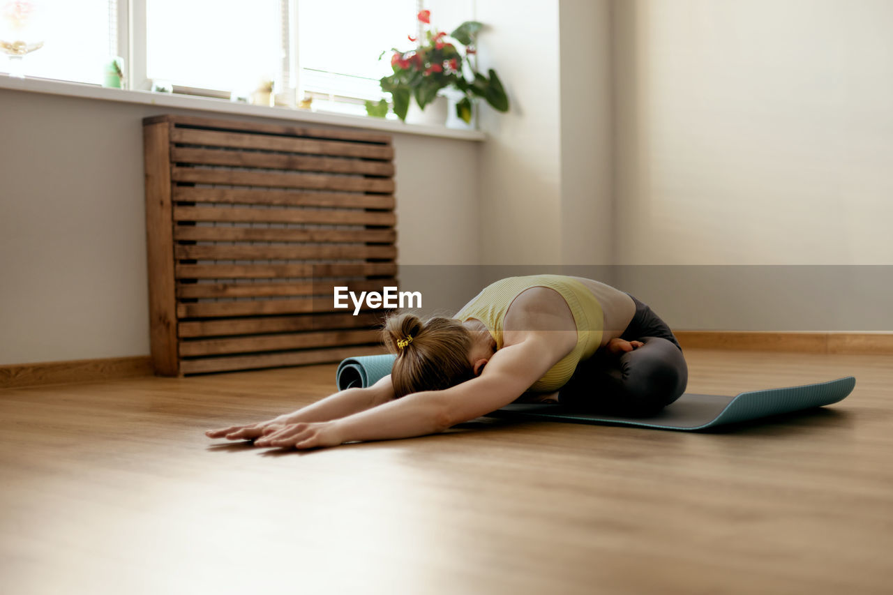 Woman exercising on floor