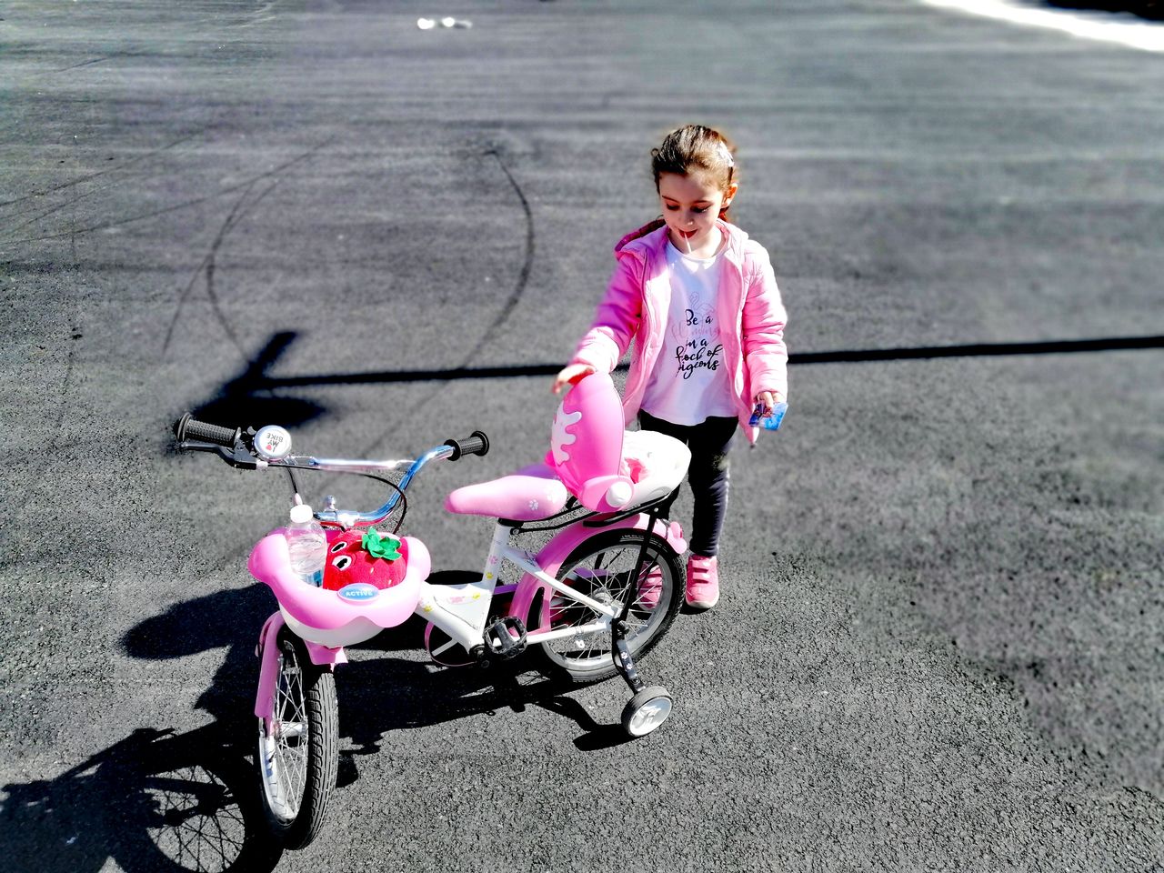 FULL LENGTH OF GIRL RIDING BICYCLE ON ROAD