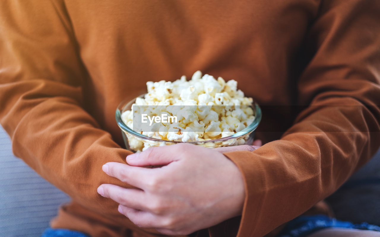 midsection of woman holding dessert