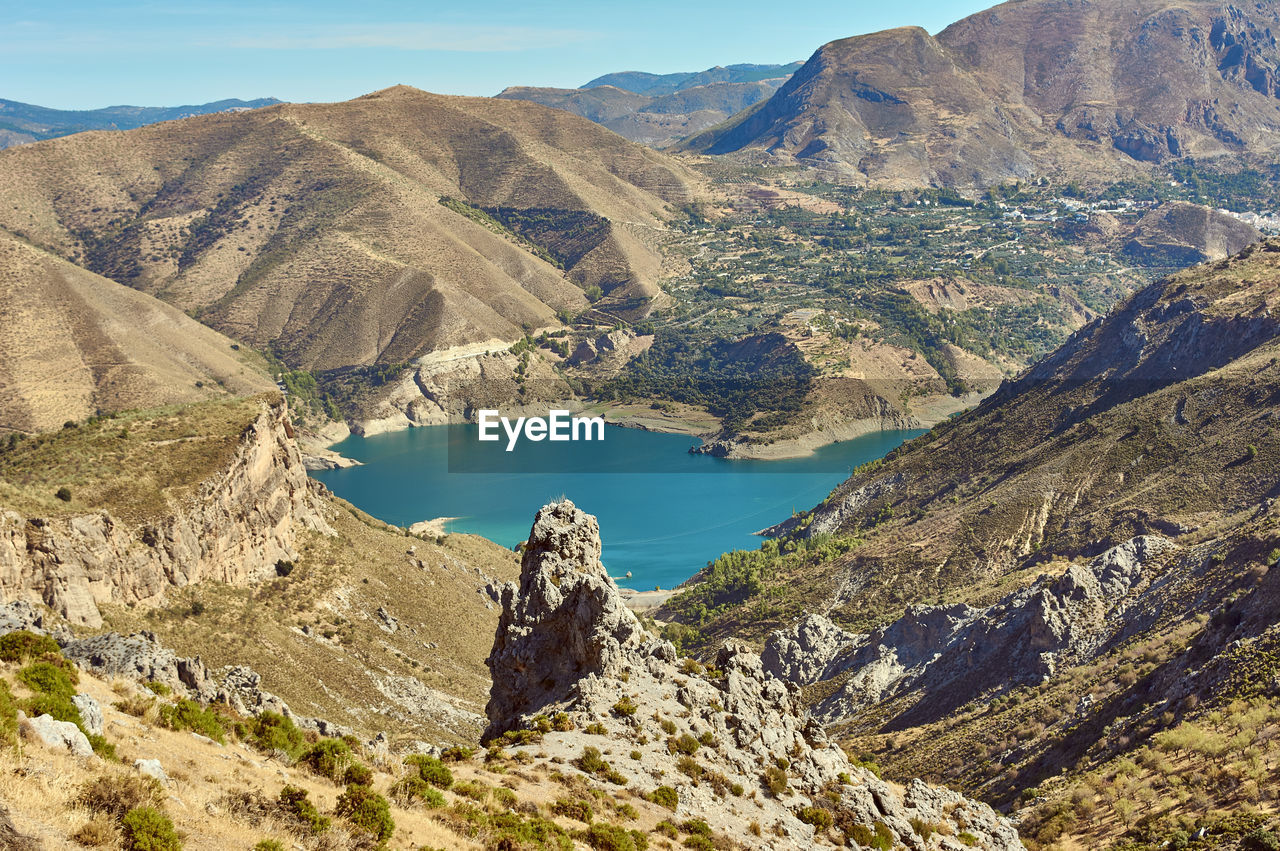 Scenic view of lake and mountains against sky