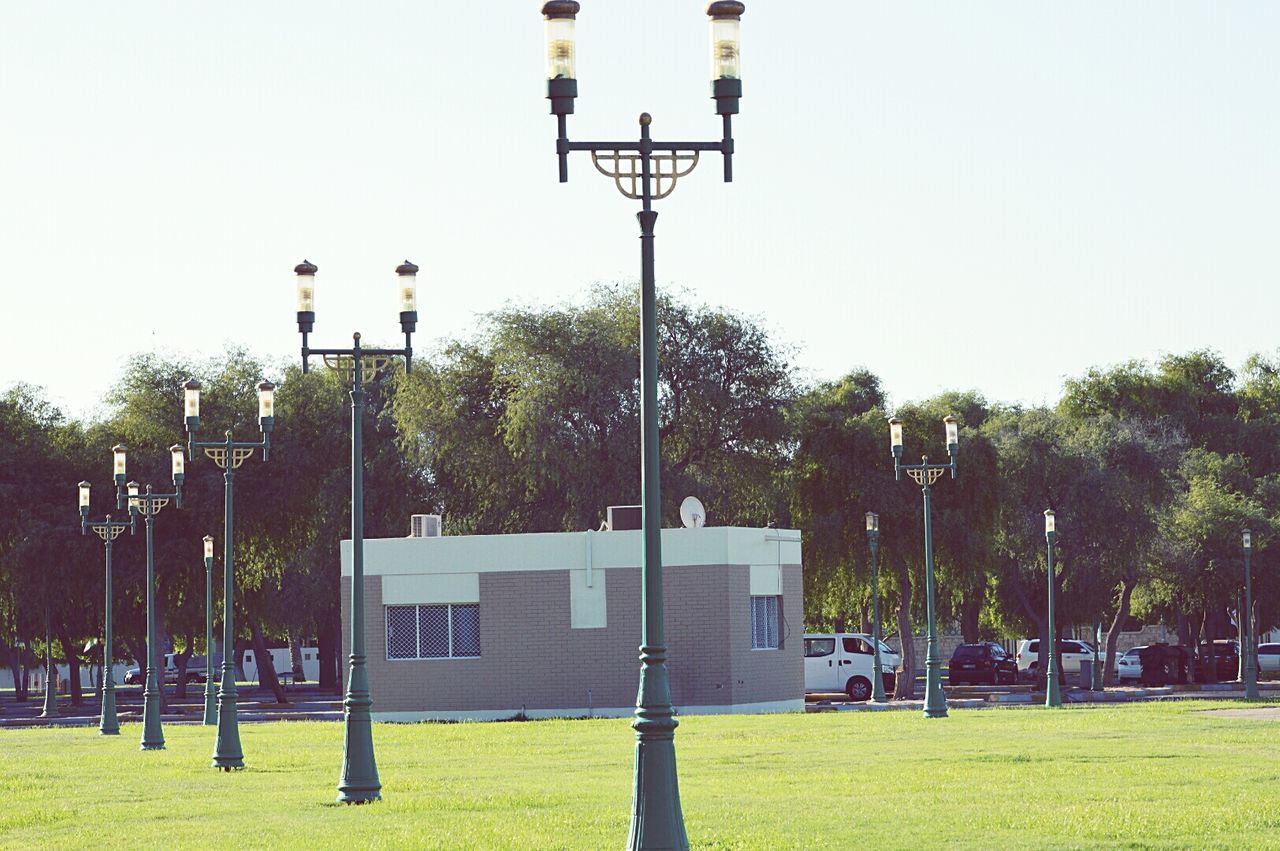 Low angle view of street light on field against sky