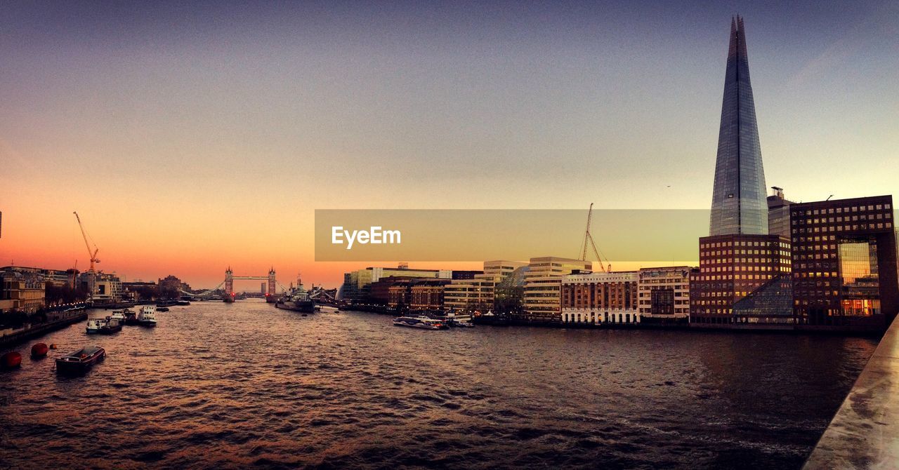 View of city at waterfront during sunset