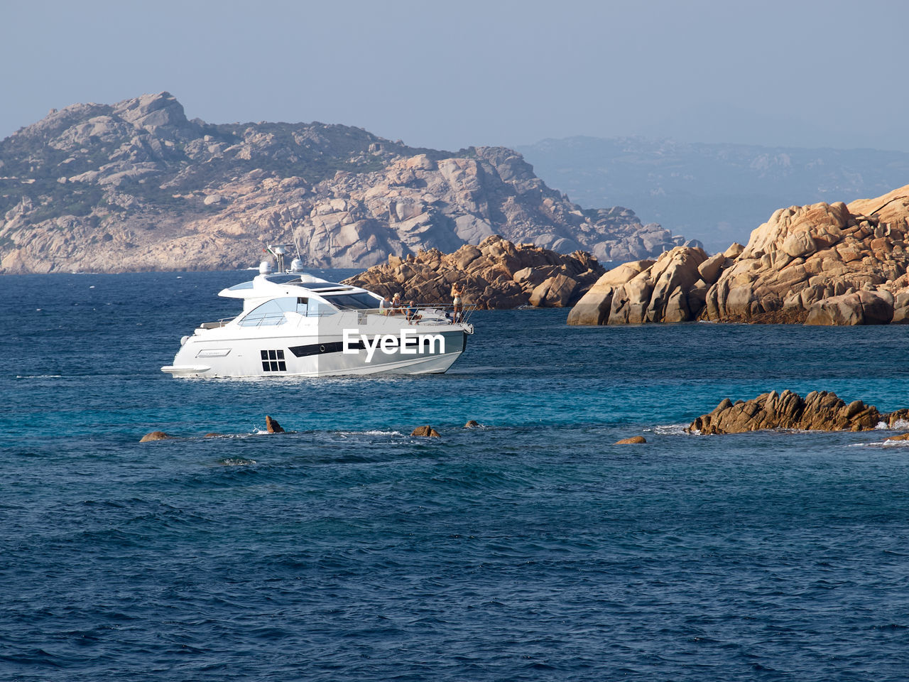 NAUTICAL VESSEL ON SEA AGAINST MOUNTAINS