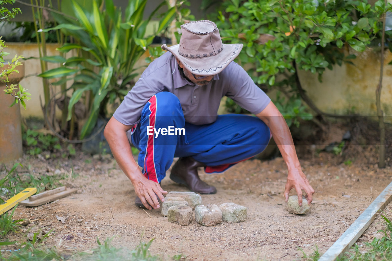 Full length of senior man sitting in farm