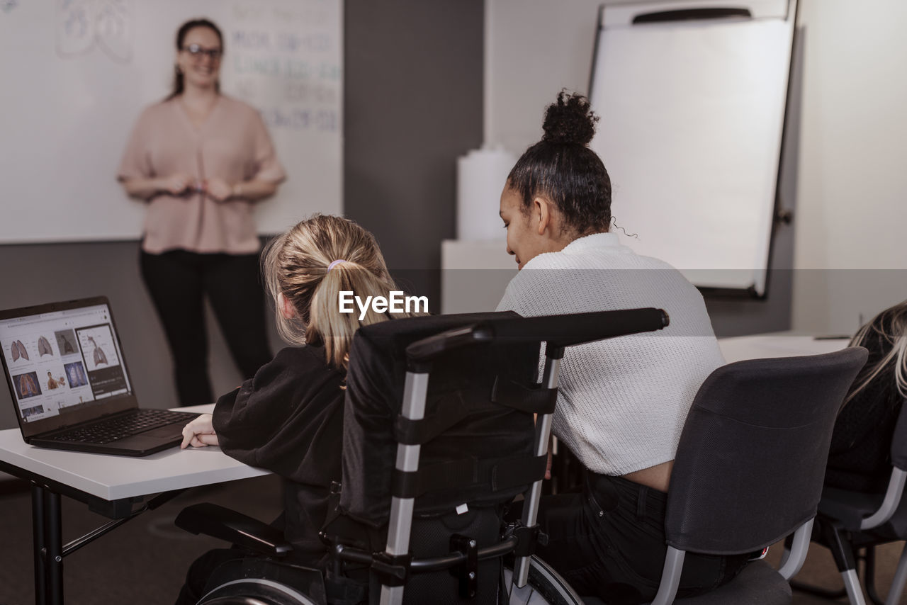 Girl on wheelchair in classroom