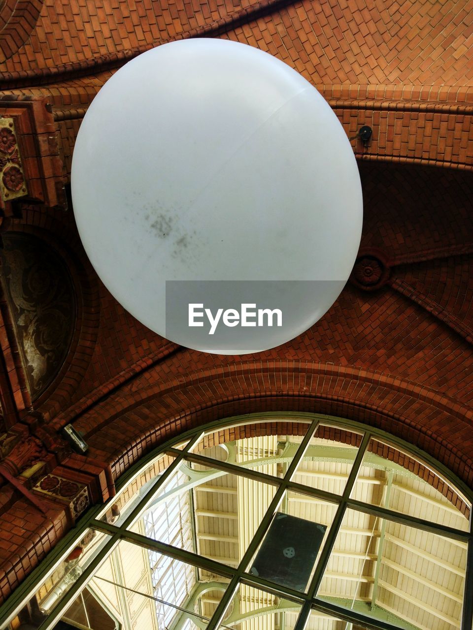 Low angle view of lighting equipment hanging on ceiling