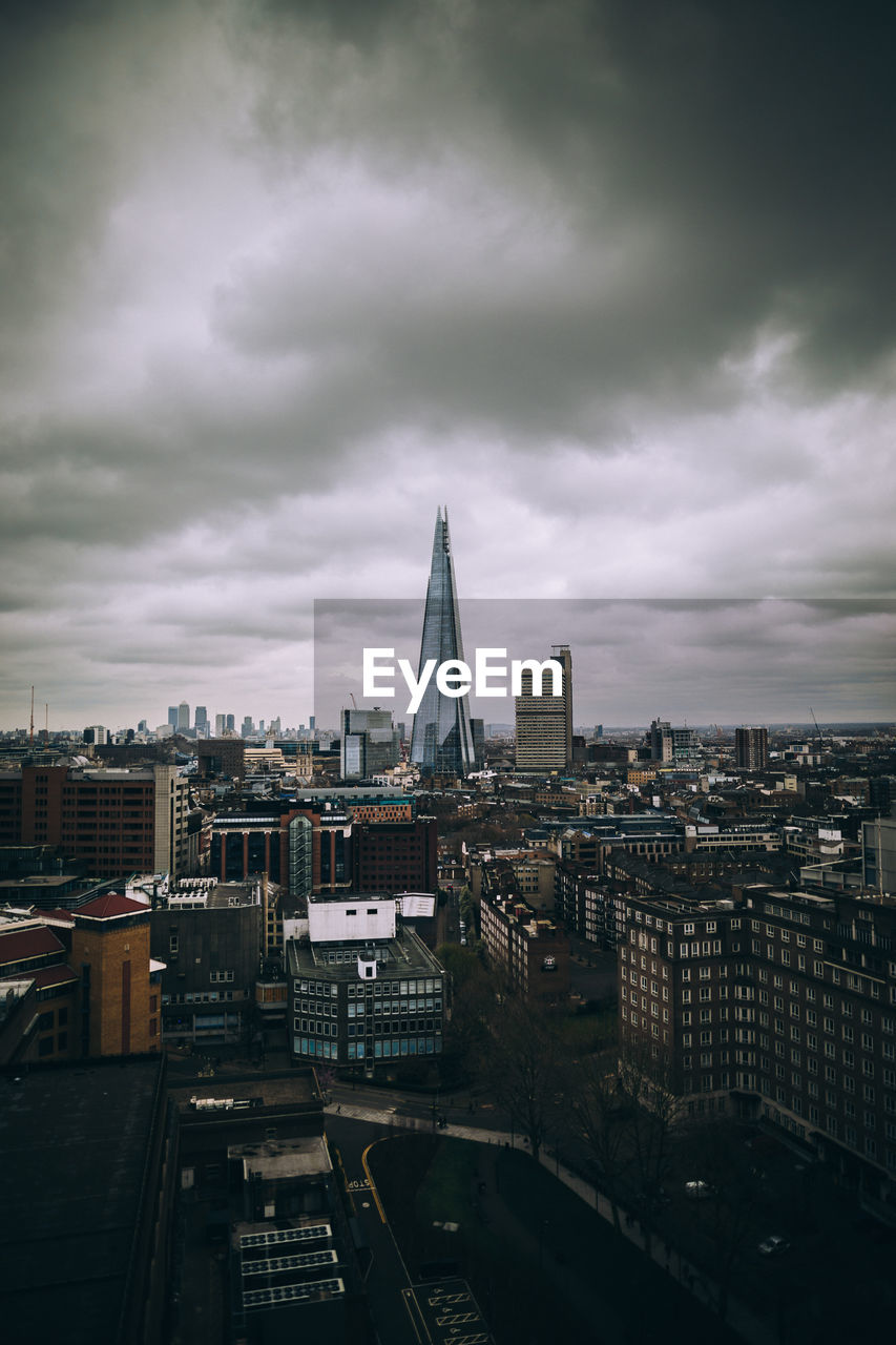 View of cityscape against cloudy sky