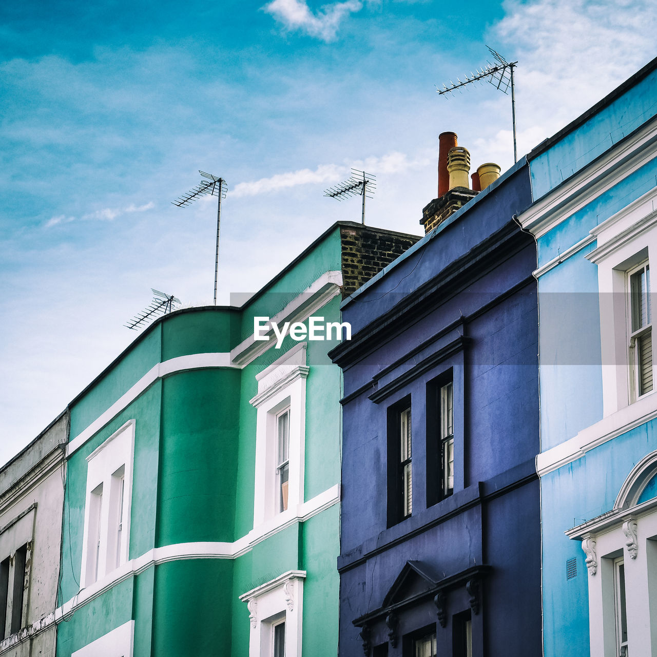 LOW ANGLE VIEW OF BUILDINGS AGAINST BLUE SKY