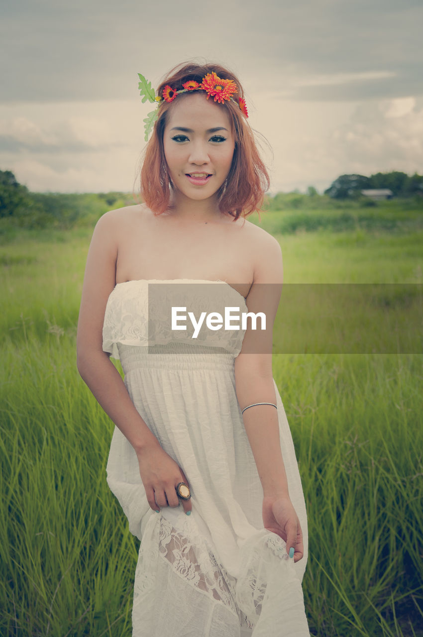 Portrait of young woman on field