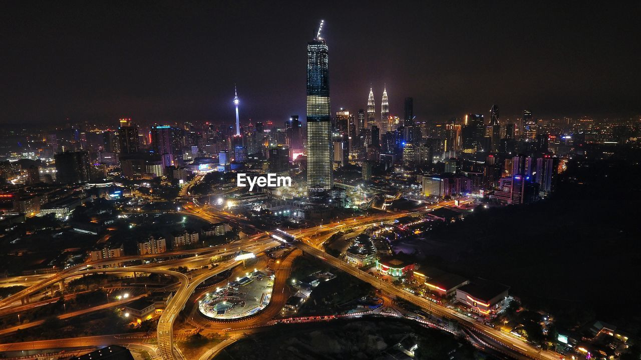 Aerial view of city lit up at night