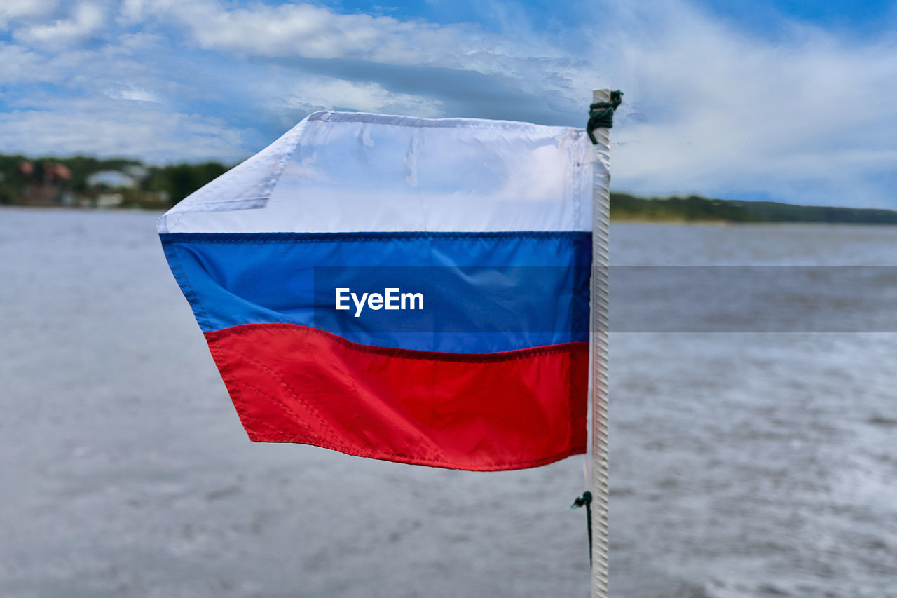 blue, flag, water, sky, nature, environment, cloud, patriotism, no people, wind, red, day, sea, outdoors
