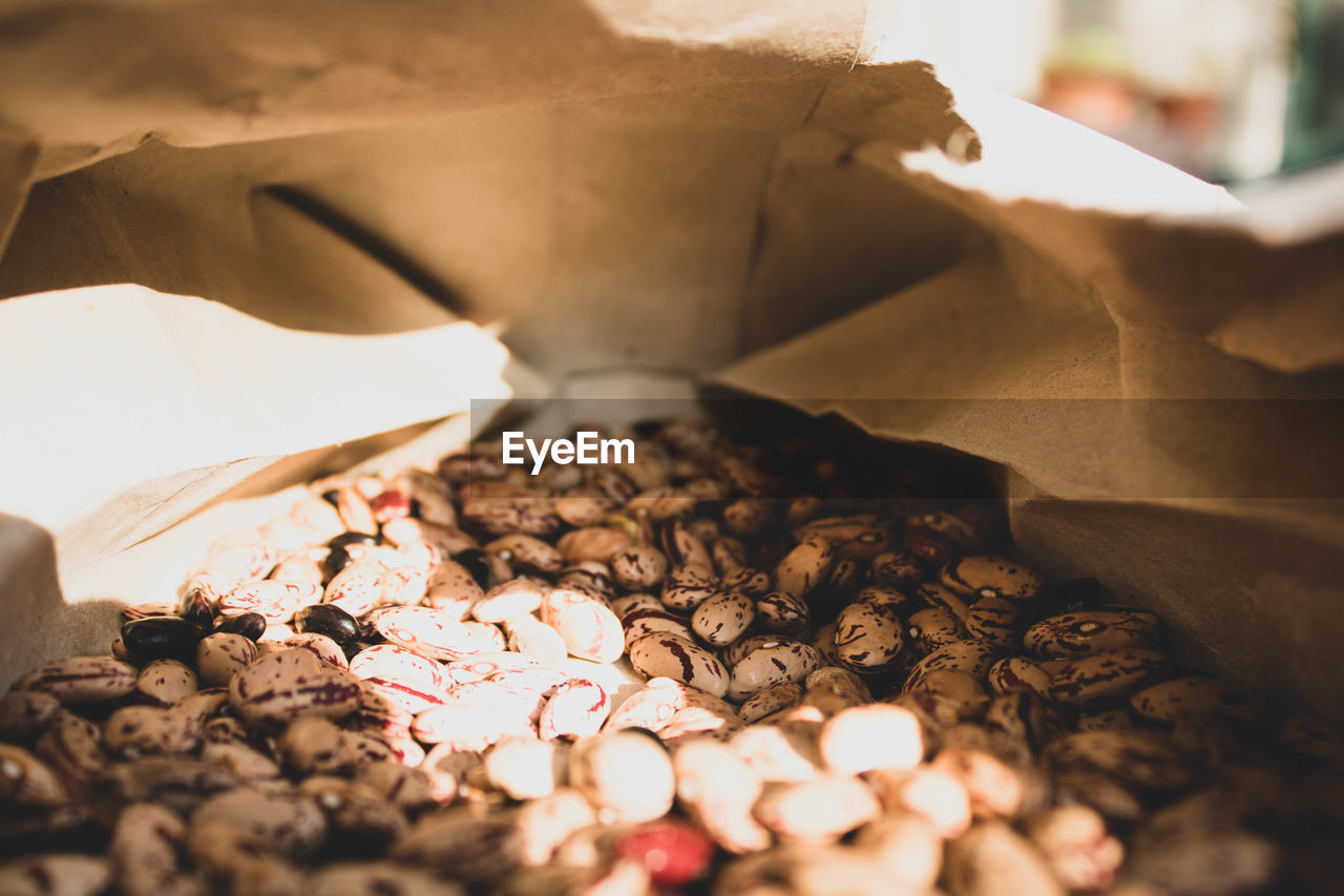 CLOSE-UP OF COFFEE BEANS ON PAPER