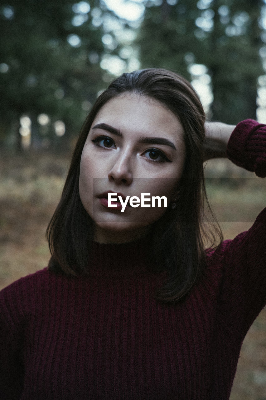 PORTRAIT OF YOUNG WOMAN WITH EYES CLOSED