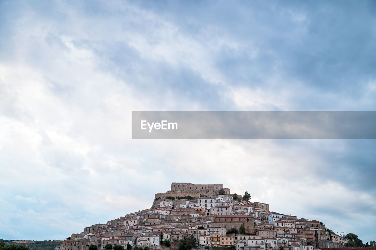 Low angle view of old building against cloudy sky