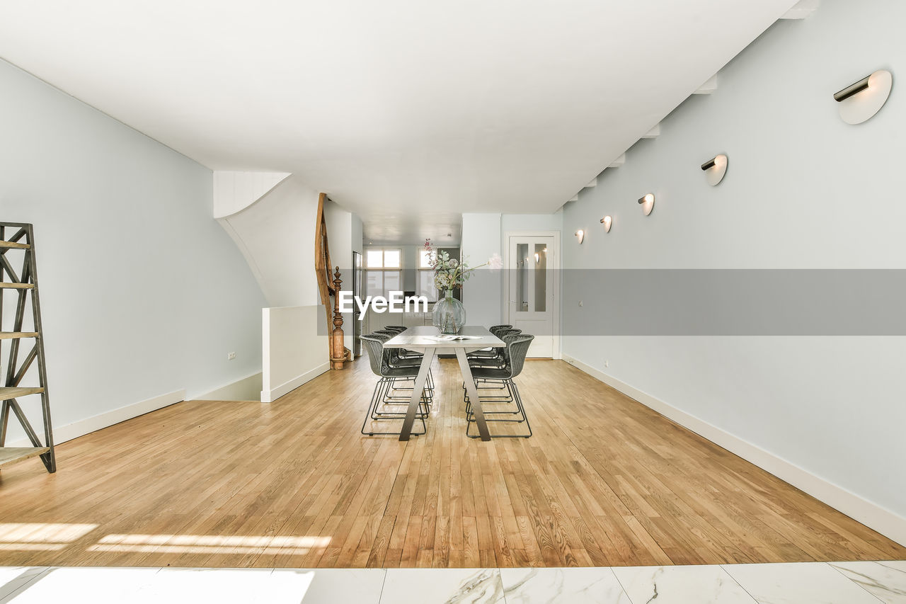 Empty chairs and tables on hardwood floor at home