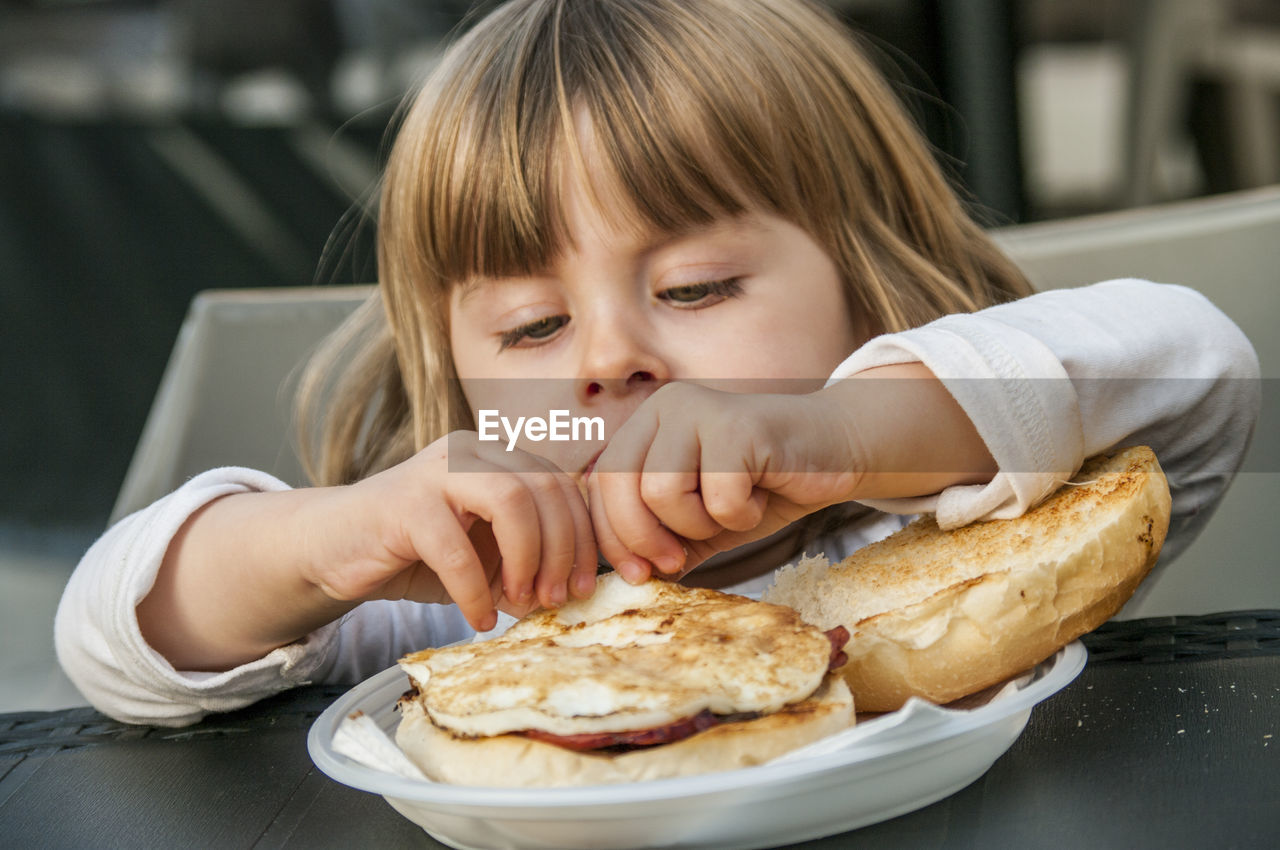 Child eating breakfast sandwich