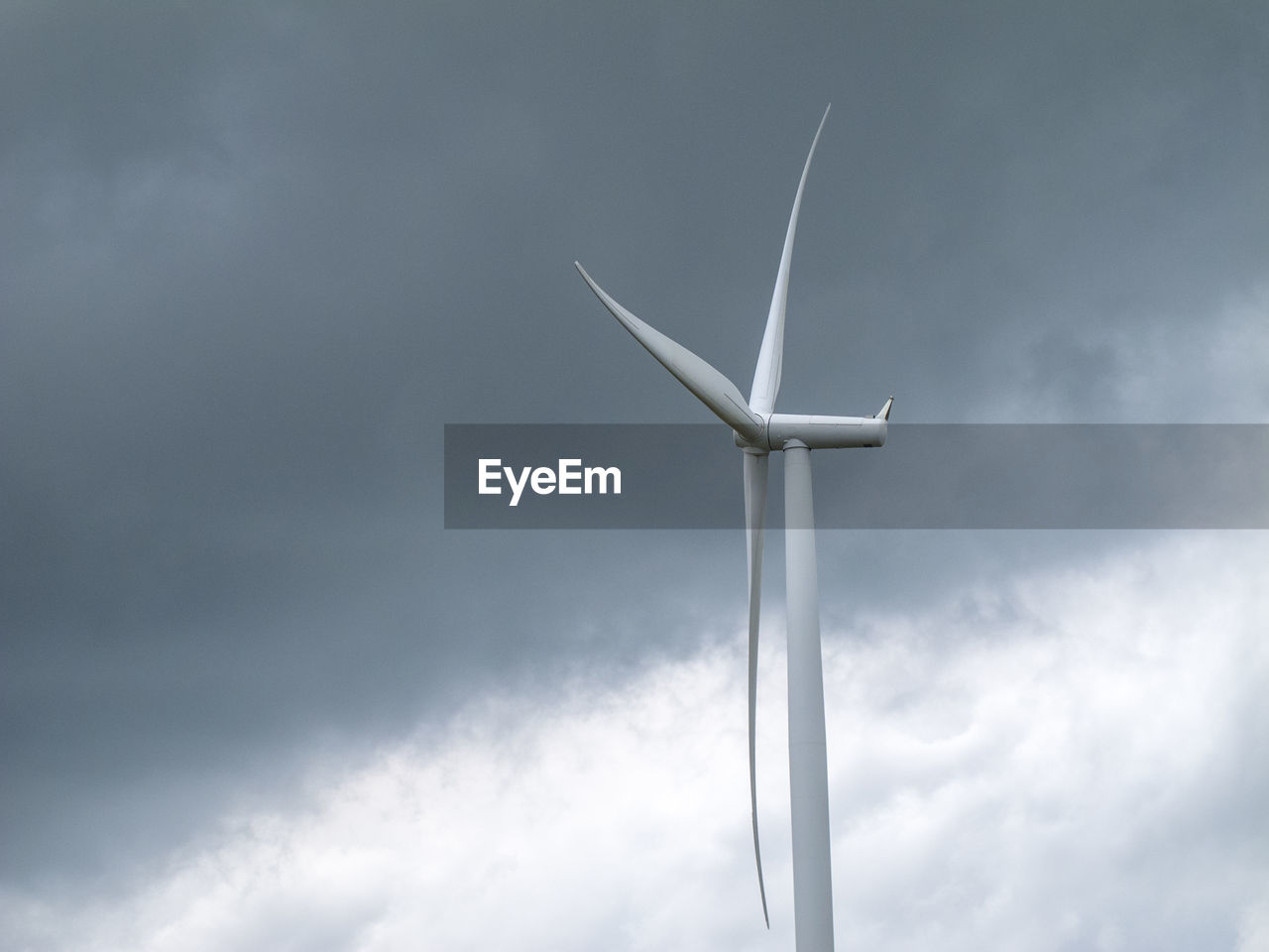 Low angle view of wind turbine against sky