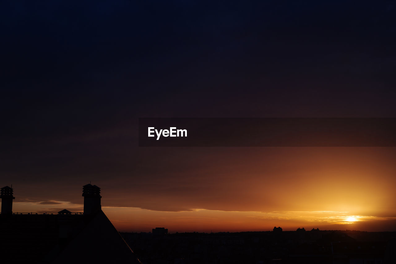 SILHOUETTE BUILDING AGAINST SKY DURING SUNSET