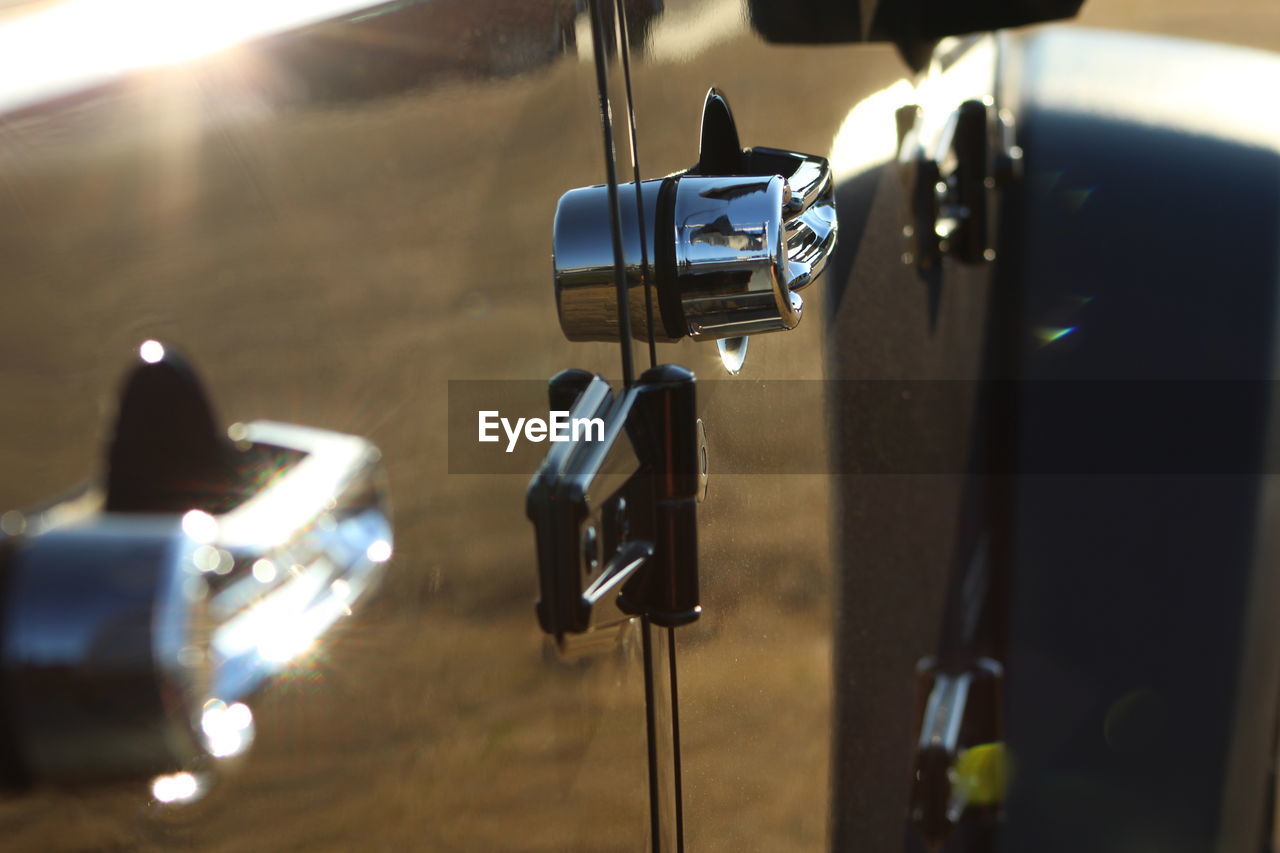Close-up of car during sunny day