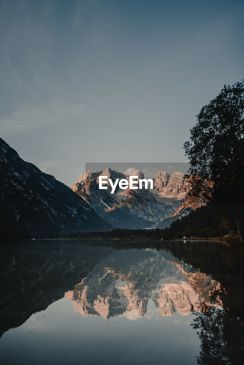 Scenic view of lake and mountains against sky during winter