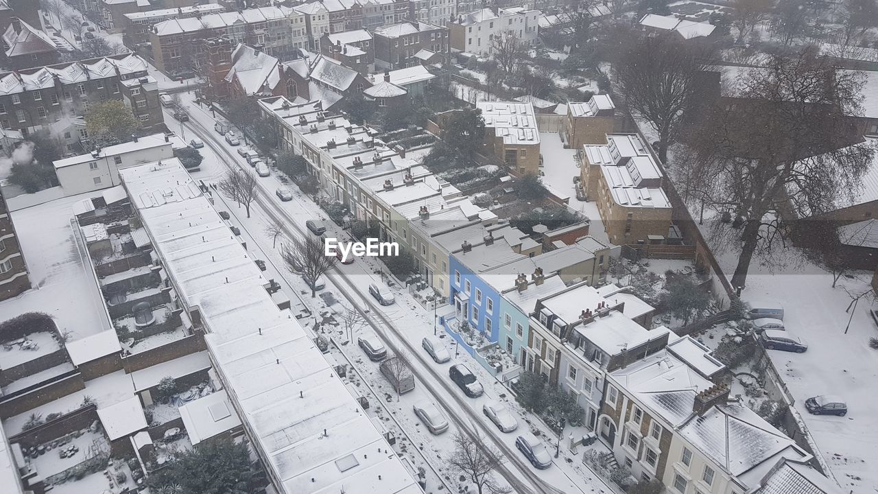 HIGH ANGLE VIEW OF CITYSCAPE AND SNOW