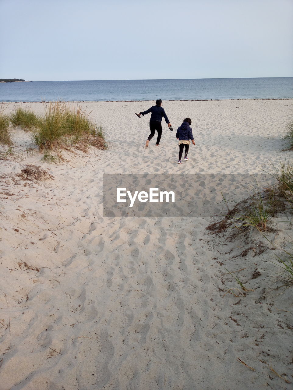 People on beach against sky