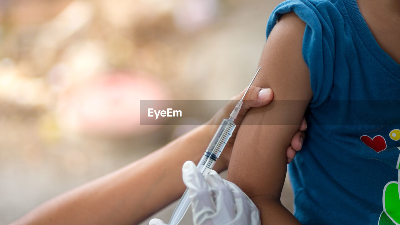 Close-up of doctor giving injection to patient