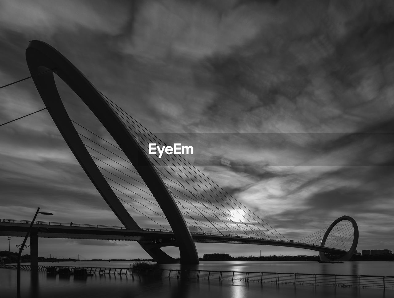 Low angle view of bridge over river against sky