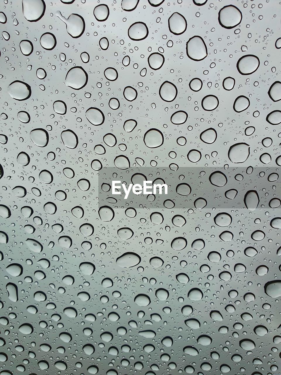 A shot of raindrops on a sunroof