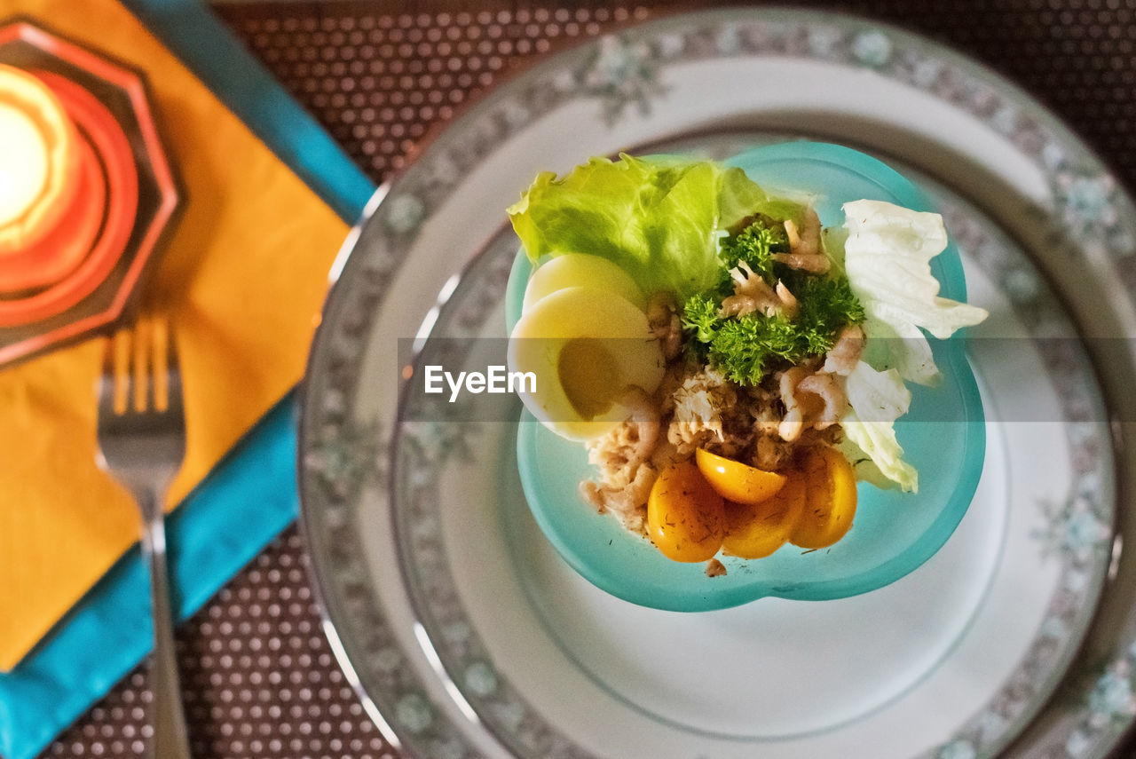 Festively served table, anticipation of christmas, sea salad in turquoise bowls