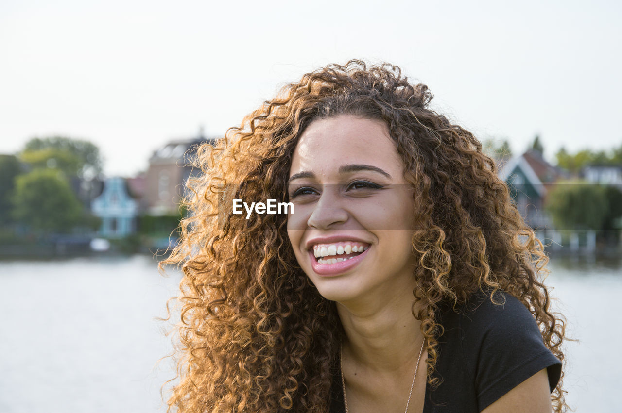 Portrait of smiling teenage girl with curly hair