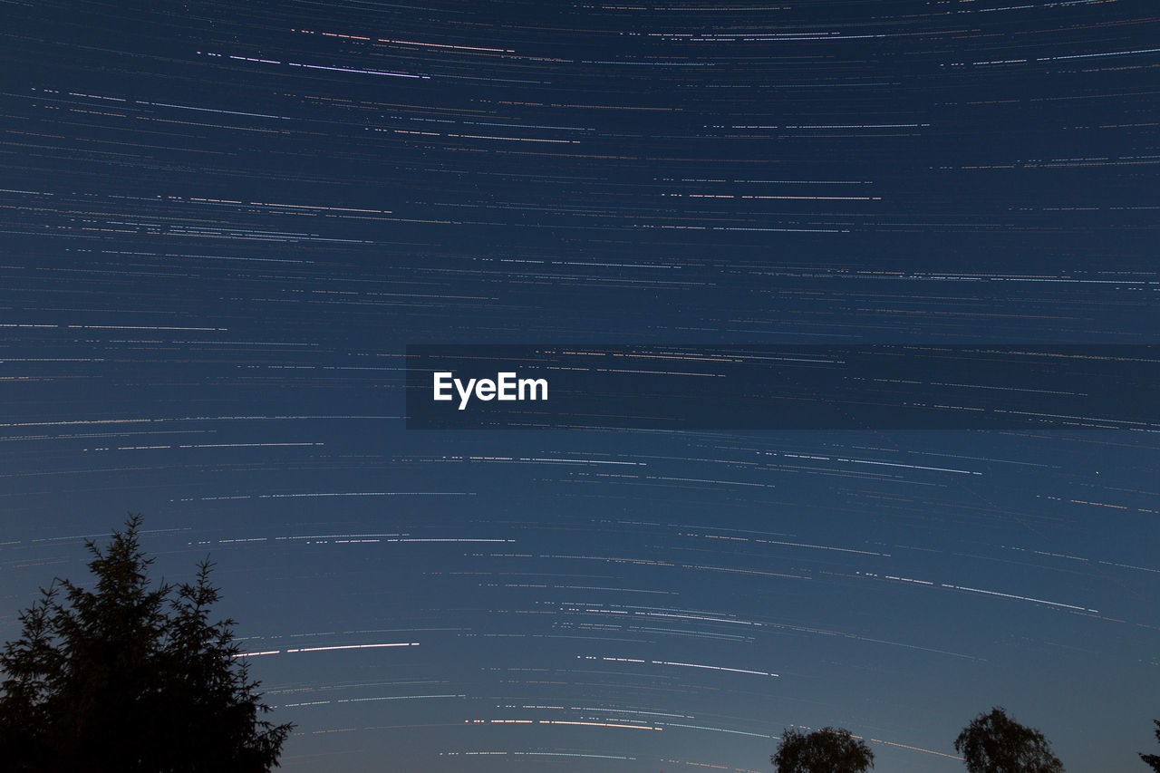 LOW ANGLE VIEW OF STAR FIELD AGAINST SKY AT NIGHT