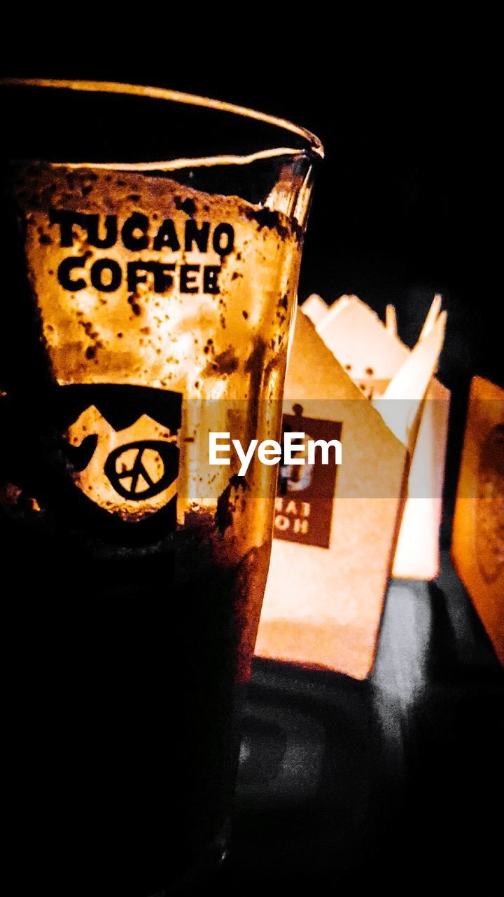 CLOSE-UP OF BEER GLASS WITH TEXT ON TABLE