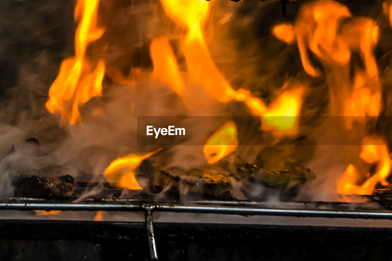 Close-up of burning fire on wood