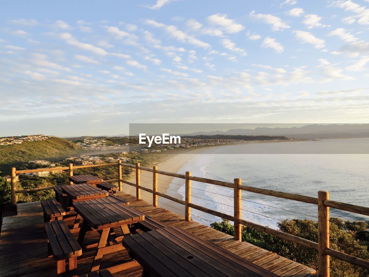 Scenic view of town and sea against sky during sunset seen from observation point