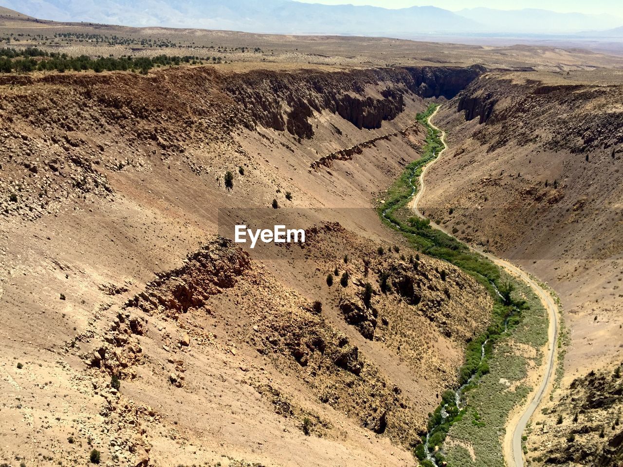 High angle view of creek amidst mountains