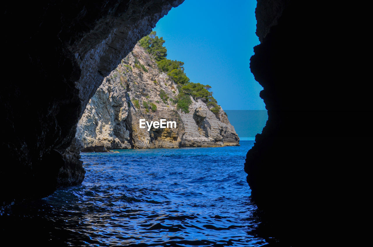 SCENIC VIEW OF SEA BY ROCK FORMATION